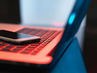 phone and laptop on table